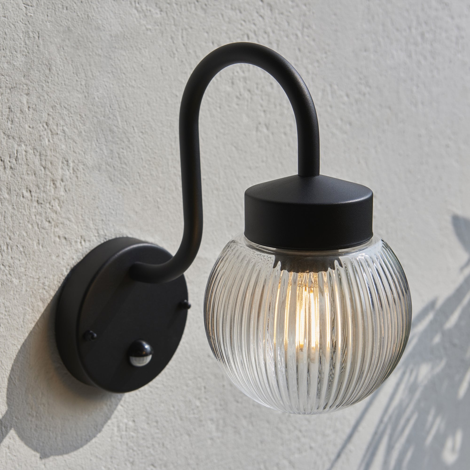 103829 Eldon Outdoor 1 Light Wall Textured Black And Clear Ribbed Glass