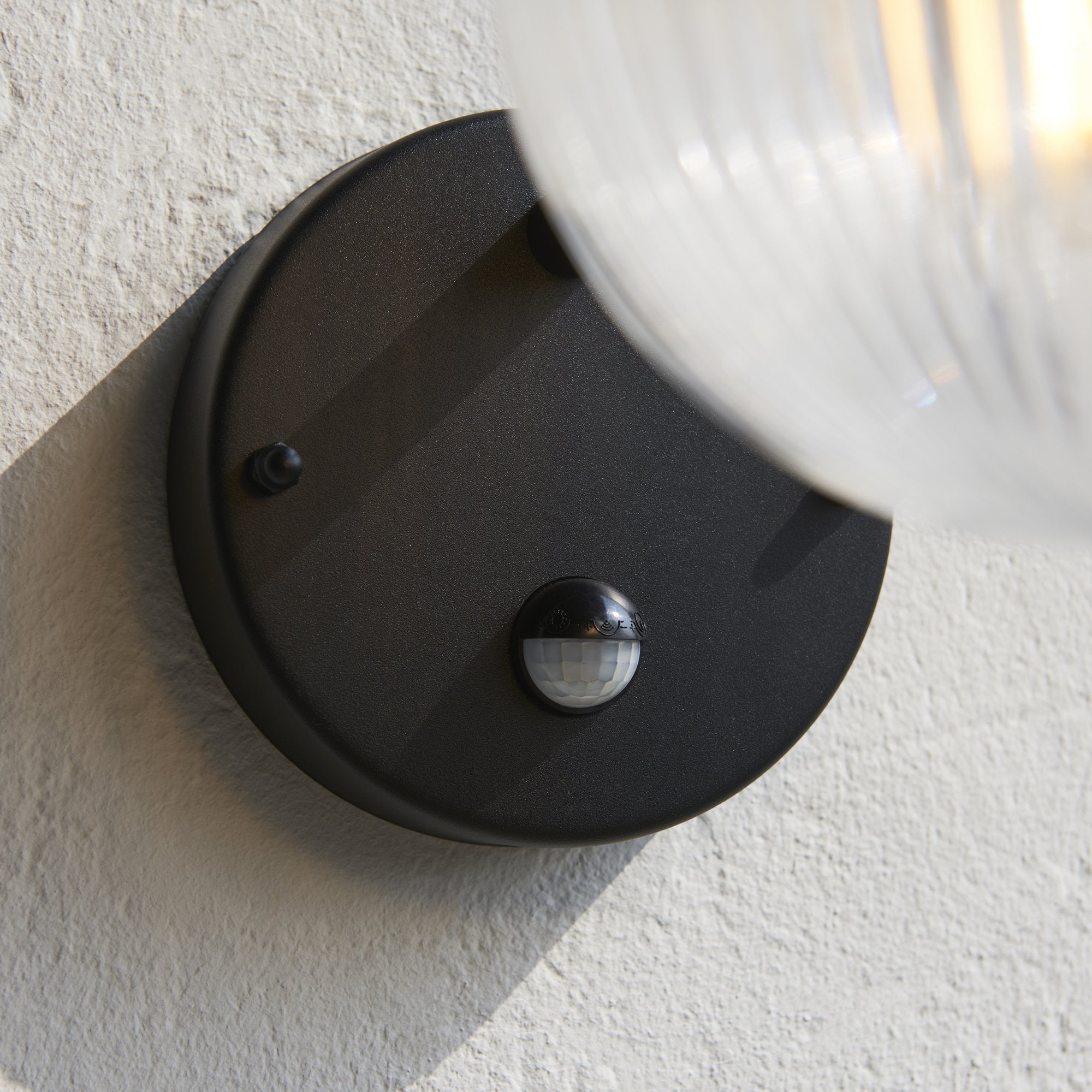 103829 Eldon Outdoor 1 Light Wall Textured Black And Clear Ribbed Glass