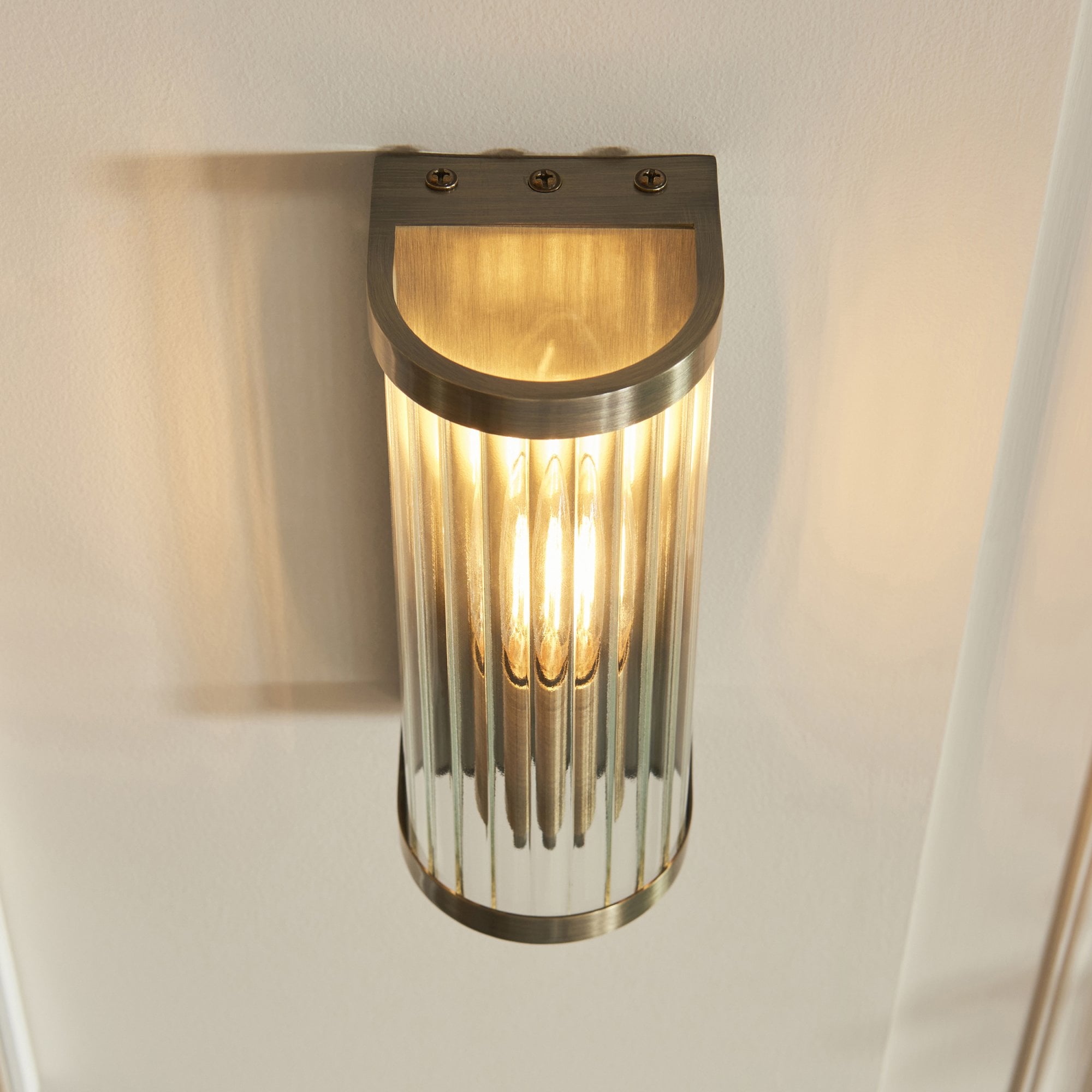 118596 Ridgeton Wall Light Antique Brass Plate & Clear Ribbed Glass