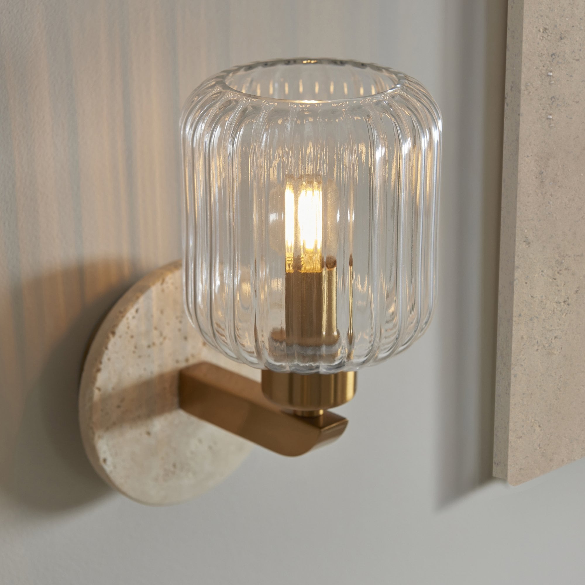 120668 Travi Ribbed Wall Light Beige Textured Marble, Vintage Brass & Clear Ribbed Glass