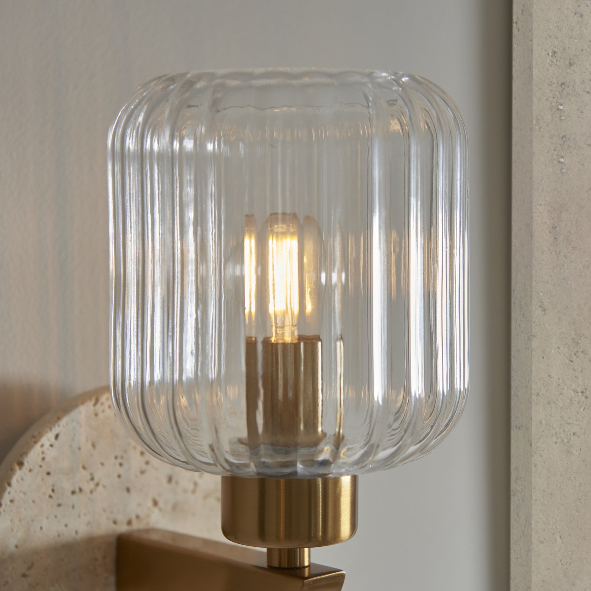 120668 Travi Ribbed Wall Light Beige Textured Marble, Vintage Brass & Clear Ribbed Glass